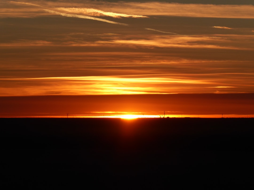 The sun is setting over the horizon of the horizon