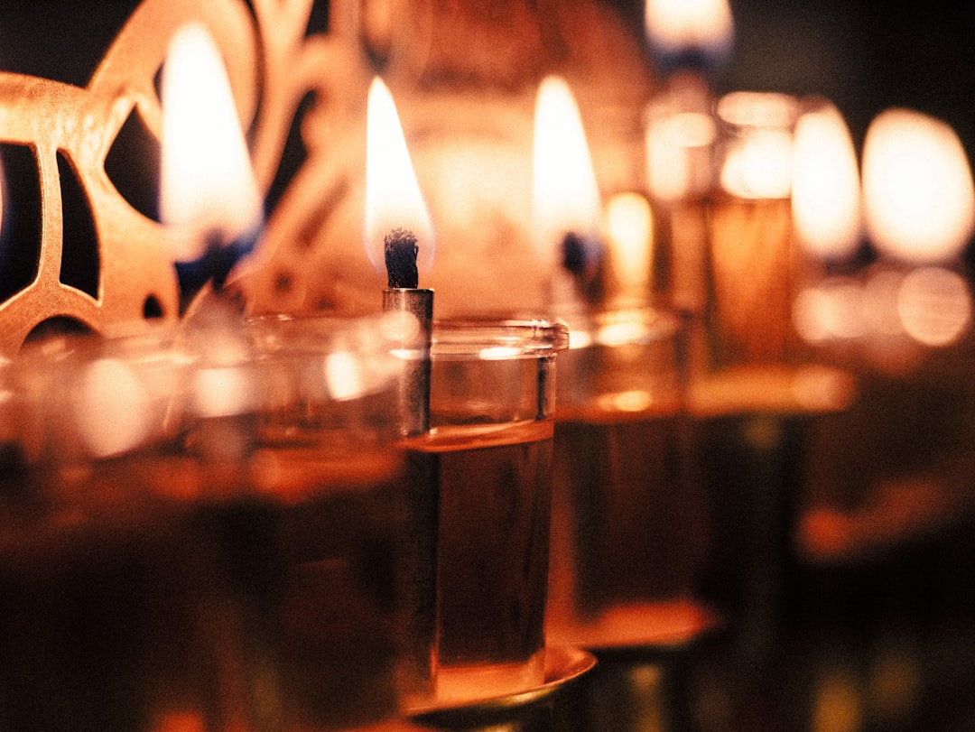 A row of lit candles sitting next to each other